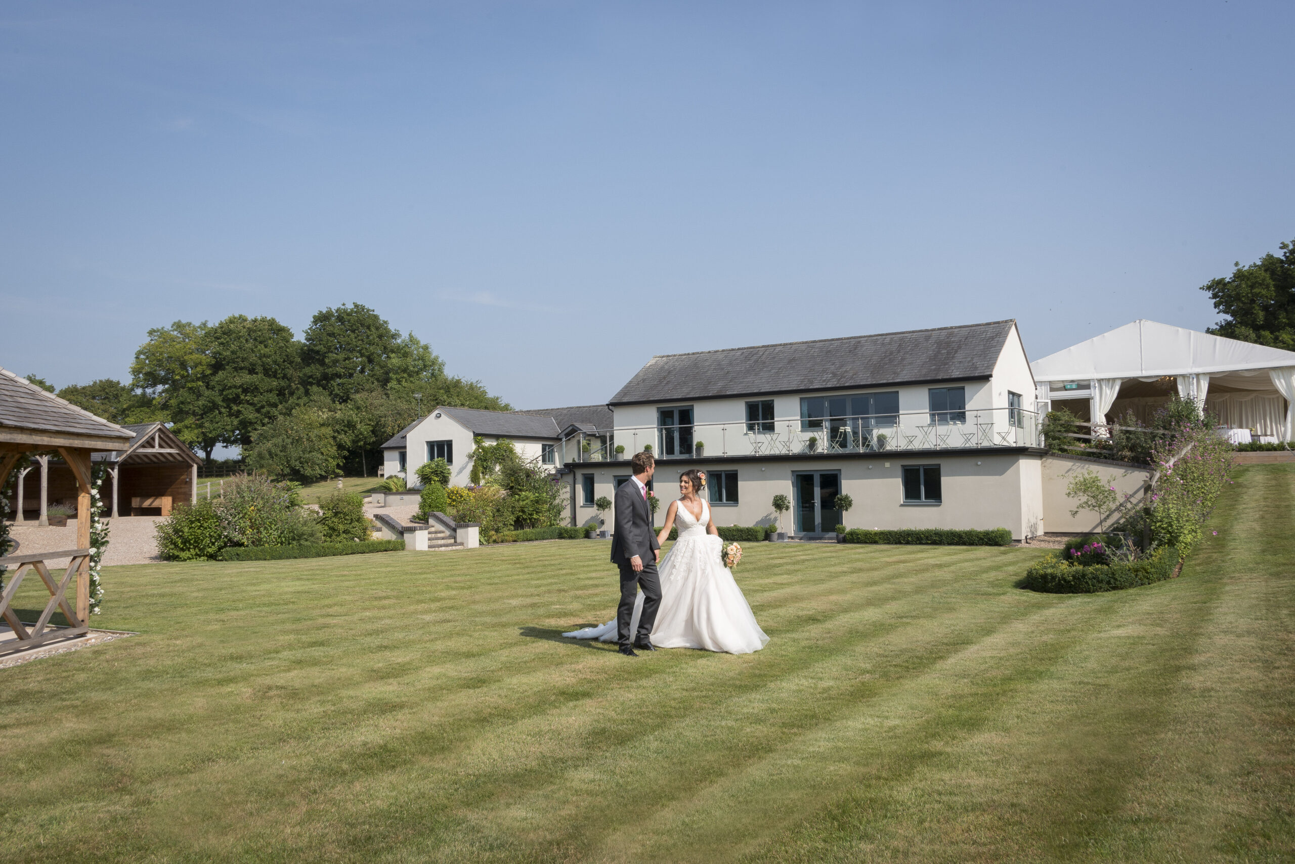 bride and groom on the lawn in front of Manor Hill House