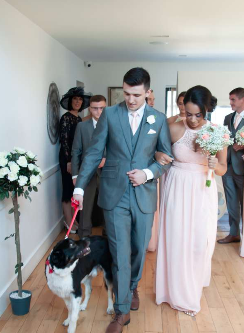 Bridesmaid and groomsman with dog