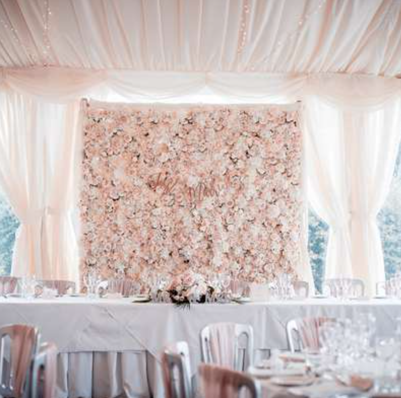 wedding breakfast set up with flower wall