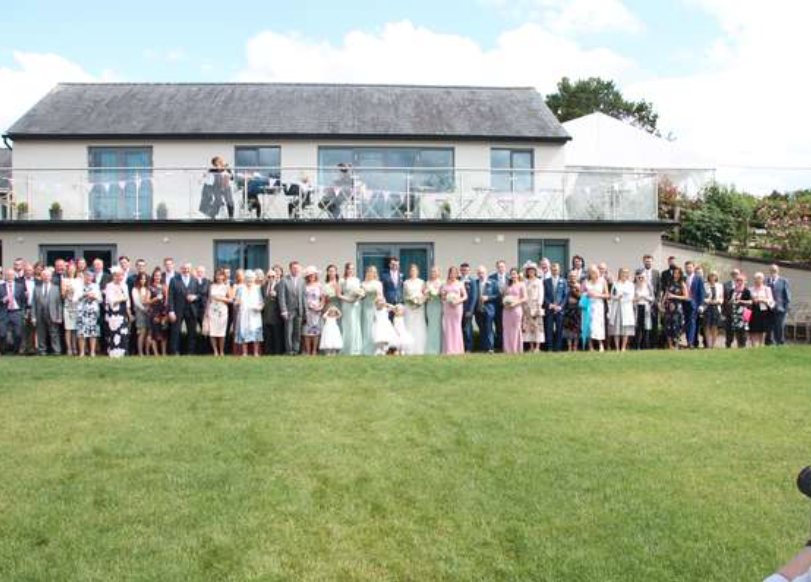 Photo of wedding party in front of Manor hill house