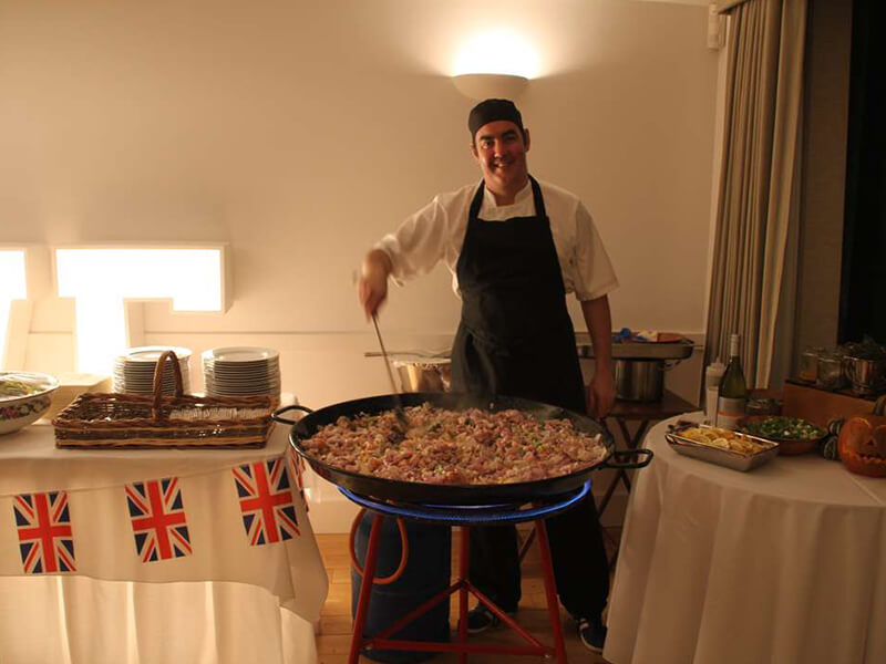 chef preparing paella evening food