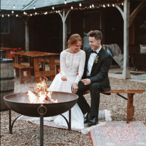 bride and groom toasting marshmallows at the fire pit