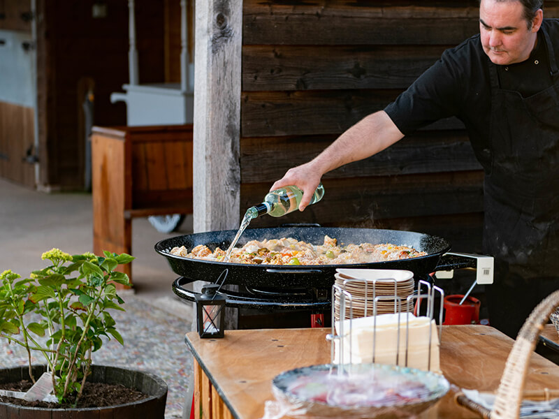 chef preparing paella outdoors