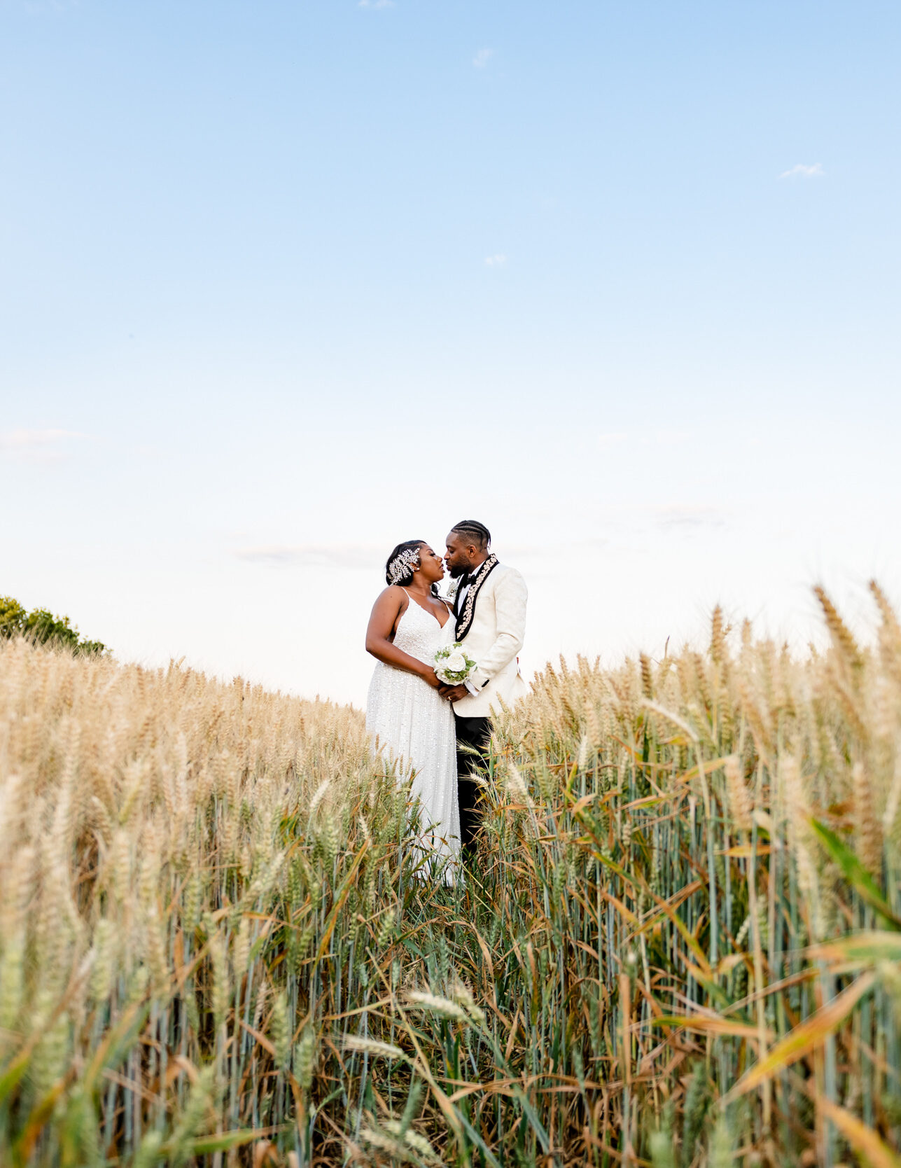 bride and groom in field of wheat