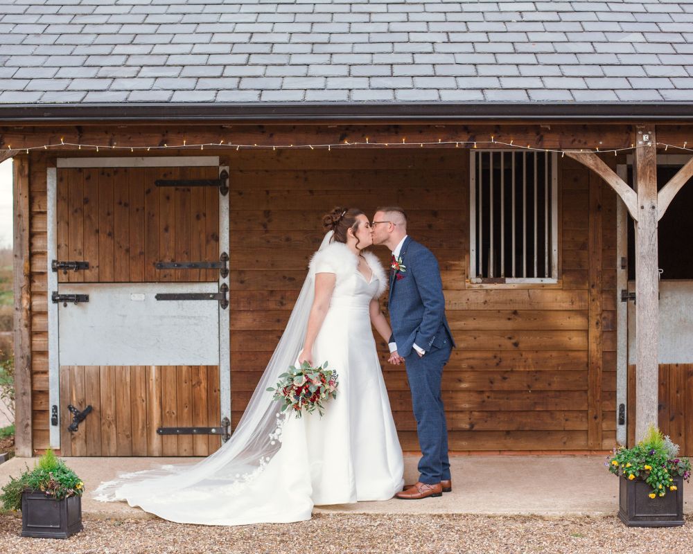 bride and groom outside the stables