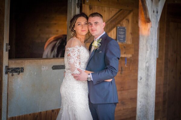 Bride and Groom in rustic stables