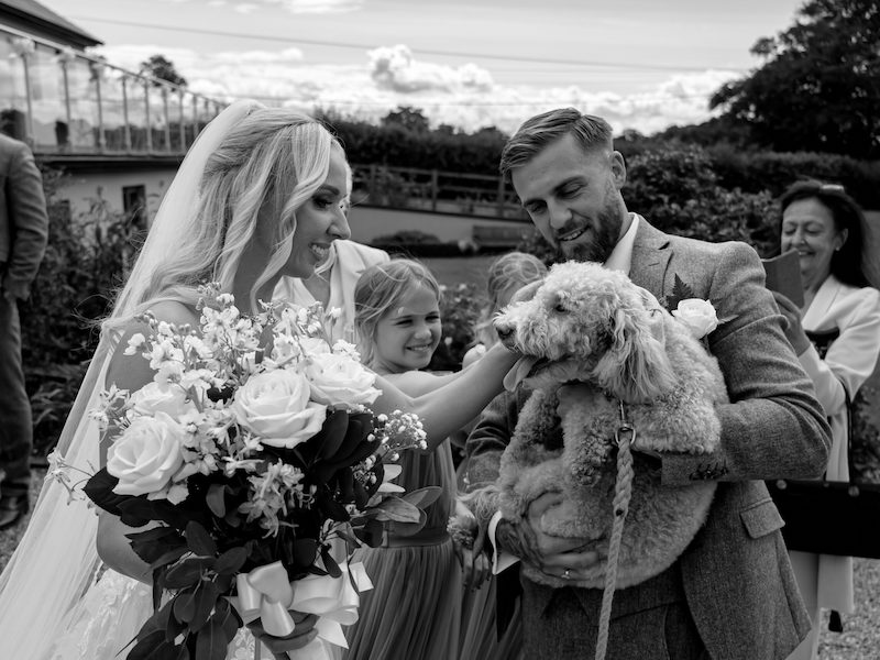 bride and groom with their dog at their wedding