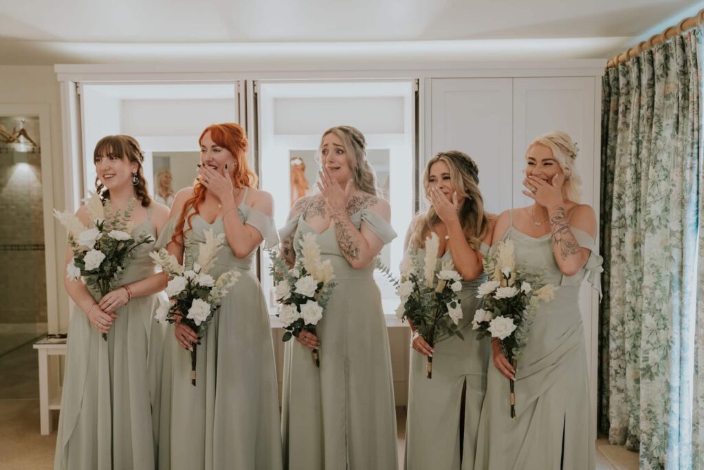 Bridesmaids reacting to seeing the bride