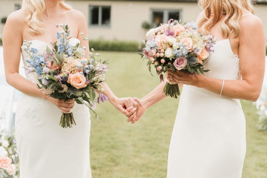 Brides holding hands outside