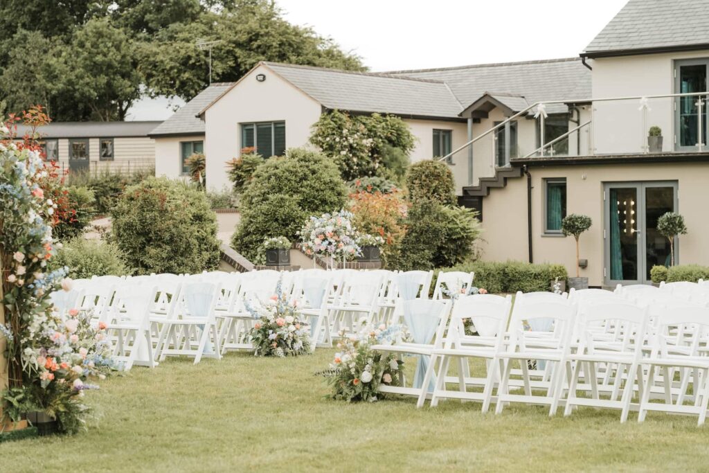 Outdoor ceremony seating with the house