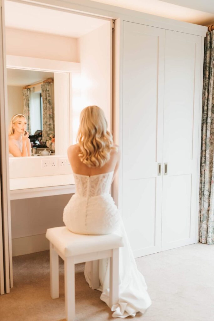 Bride getting ready in wedding dress in the honeymoon suite