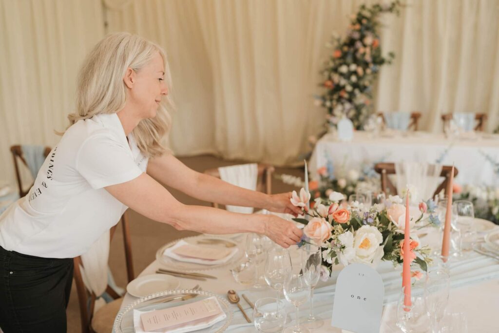 White Violet Venue Styling preparing centrepieces