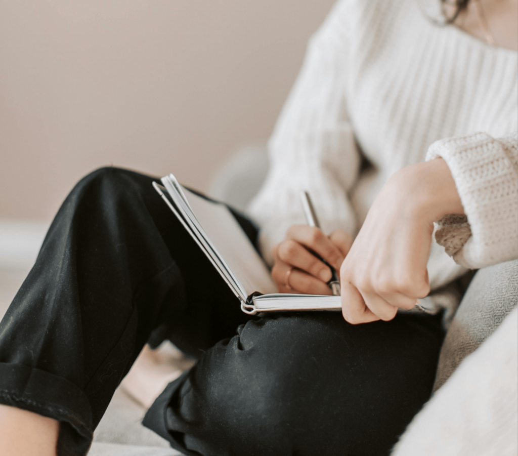 A woman sat with a notebook planning