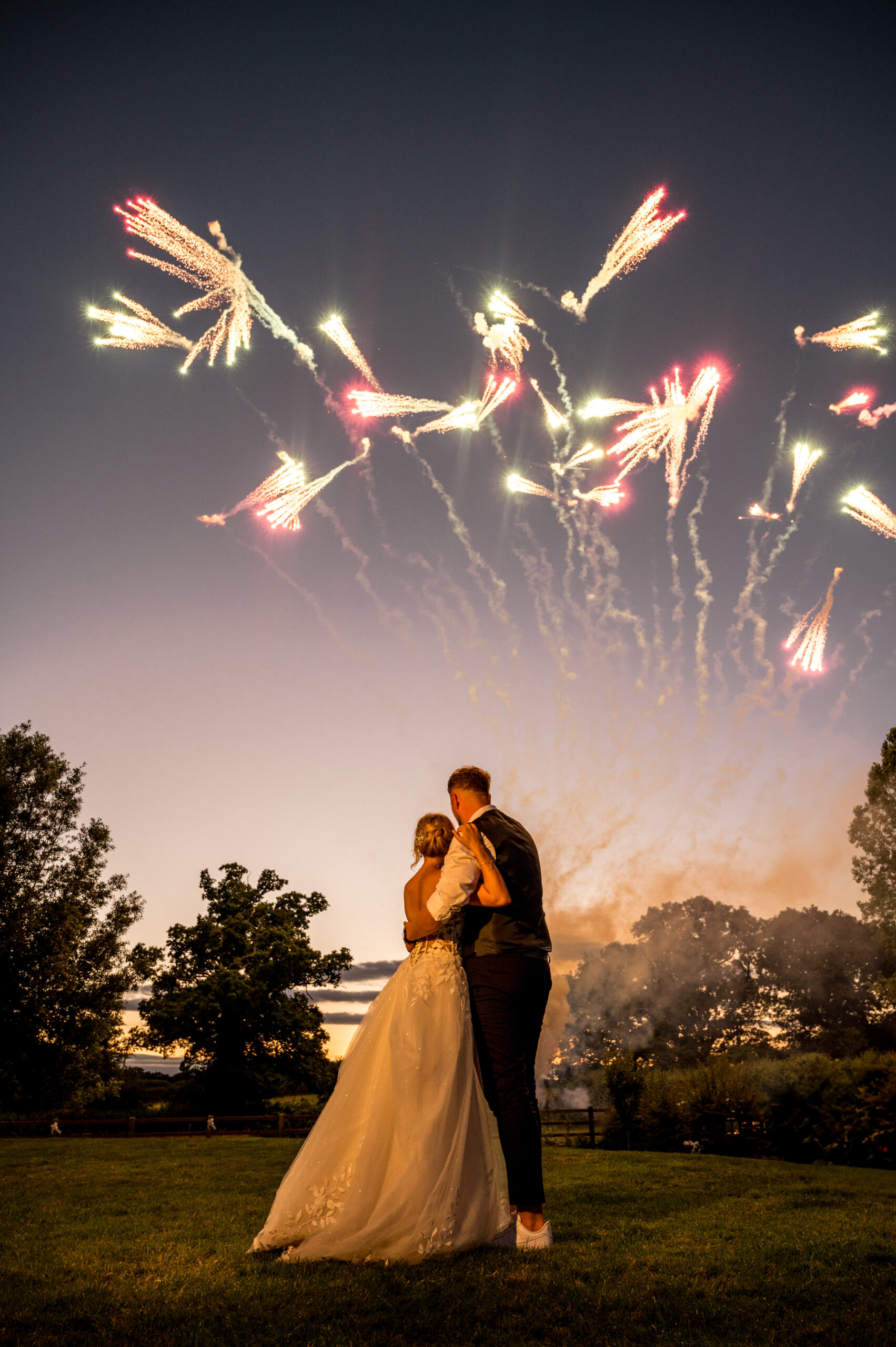 Bride and groom celebrating with fireworks