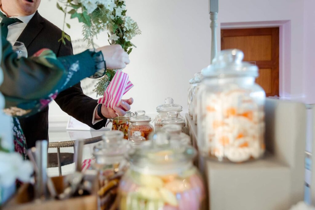 A wedding guest taking sweets from our sweet cart