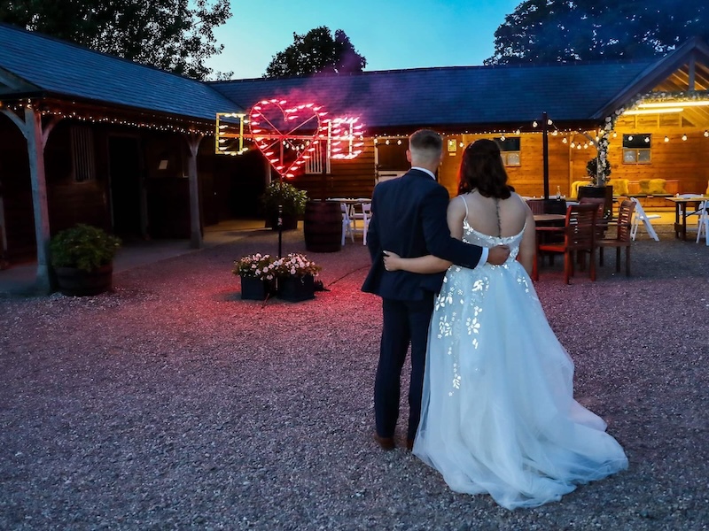 Couple watching fireworks by the barn